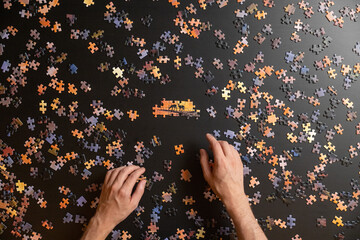 Hands putting a puzzle together