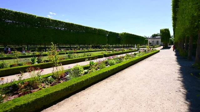Versailles, Paris, France, June 2022. Nice pov footage walking along the gardens of the Petit Trianon. Beautiful summer day.