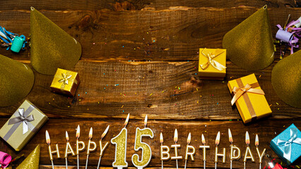 golden letters of the candle with the number happy birthday, the background of the gift boxes with...