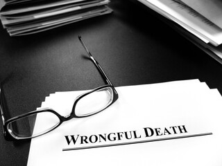 Wrongful Death Papers on Desk for Lawsuit with Glasses