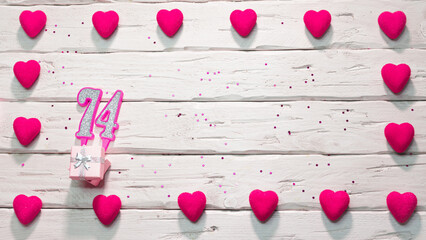 Happy birthday card for a girl in pink shades, top view, copy space. Beautiful congratulations with numbers and hearts, a place for your text. happy birthday candle number 74