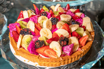 delicious and fresh pies with sortiment  fruits like , banana, strawberry, ananas, peach, grape,