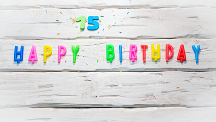Top view of happy birthday candle numbers copy space on wooden white pastel boards. Beautiful...