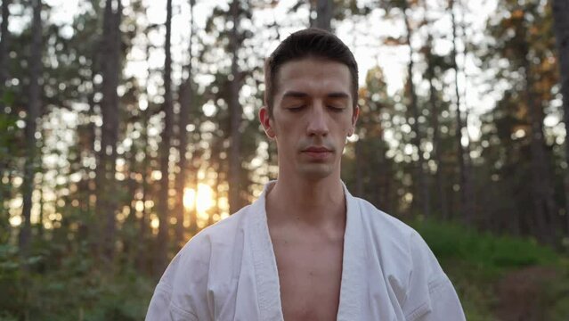 One man karateka meditate during karate training practice in the woods mind peace and strength concept
