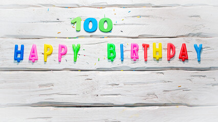 Top view of happy birthday candle numbers copy space on wooden white pastel boards. Beautiful...