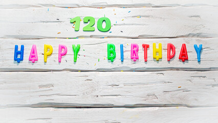  Top view of happy birthday candle numbers copy space on wooden white pastel boards. Beautiful...