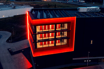 Red windows with neon illumination at night, a bright building in red, red windows and doors