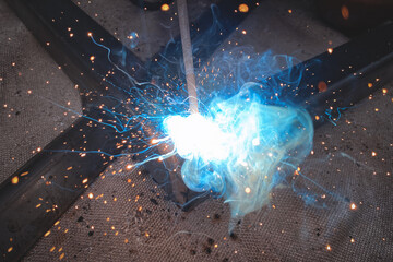 Electric arc welding in production, metal structure welding, large flash of light