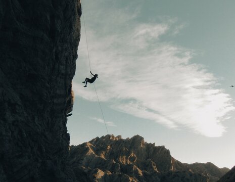 rappelling off a cliff in the desert