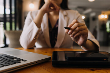 Businessman and team analyzing financial statement Finance task. with smart phone and laptop and...