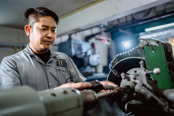 Factory mechanics in uniform using a micrometer to measure intside diameter metal after grinding in...