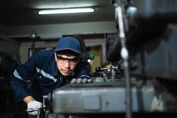 Engineer mechanical in safety suits working with grinding machine metal in the factory, Technician...