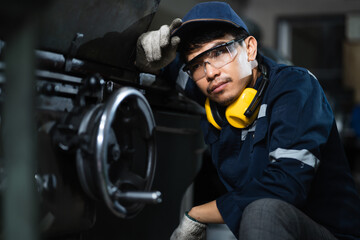 Engineer mechanical in safety suits working with grinding machine metal in the factory, Technician maintenance and check machinery, manufacturing steel industry.