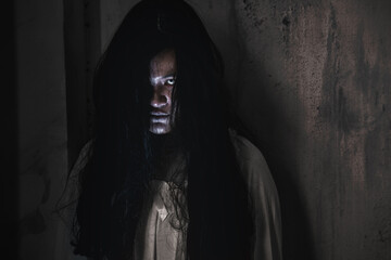 Scary ghost woman. Portrait of Asian ghost or zombie horror creepy scary have hair covering the...