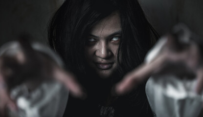 Naklejka na ściany i meble Scary ghost woman. Asian ghost or zombie horror creepy scary have hair covering face and eye reach arm out at abandoned house dark room, female makeup terror zombie face, Happy Halloween day concept