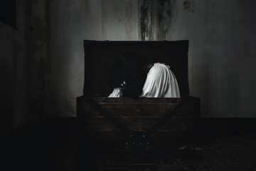 Horror ghost woman. Asian ghost horror creepy scary have hair covering face and eye lying in the...