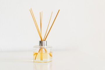 Spa therapy, aromatherapy. Diffuser bottle on a white background. Incense sticks for the home with a floral scent. The concept of eco-friendly fragrance for the home