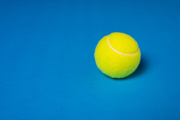 Tennis Ball With Copy Space on Blue Background 