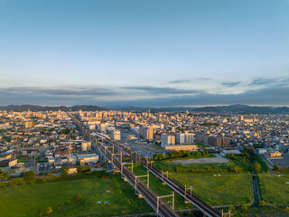Aerial view of train tracks leading to central Himeji City in early morning