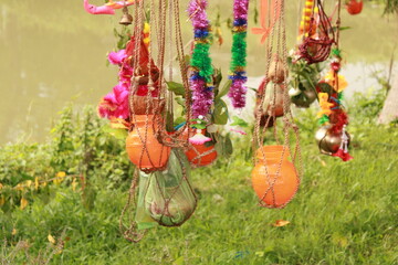 Closeup of Kanwarias kept their Holy Gangajal pots. Small bamboo pole on which two earthen, plastic and brass pots are hung on either end for carrying the Gangajal coconut, flower, mango leafs.