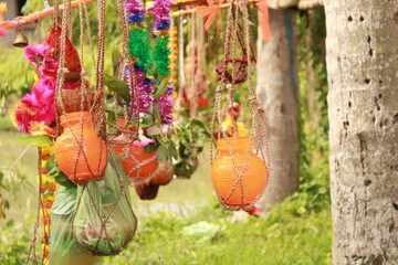Fototapeta premium Closeup of Kanwarias kept their Holy Gangajal pots. Small bamboo pole on which two earthen, plastic and brass pots are hung on either end for carrying the Gangajal coconut, flower, mango leafs.