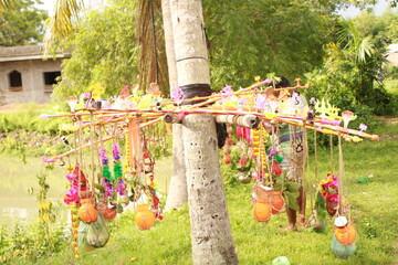 Closeup of Kanwarias kept their Holy Gangajal pots. Small bamboo pole on which two earthen, plastic...