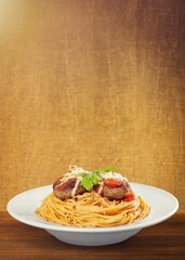 Homemade Italian spaghetti pasta with sauce, tomatoes, basil and parmesan. Traditional cuisine. Served