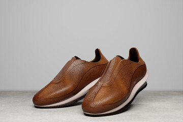3D illustration of a concept shoe for the metaverse. Brown  casual boot sneaker on a white platform.