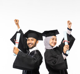 Excited graduate boy and girl in toga holding certificates and clenching fists on isolated background