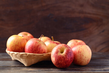 Red apple fruit in basket on wooden background, Healthy fruit