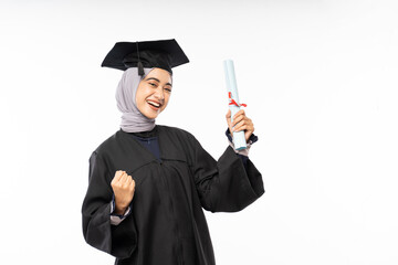 Excited female graduate student in black toga holding certificate roll on isolated background