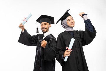 Female and male graduate students wearing togas with clenched hands on isolated background