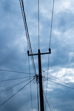 Electric pole on blue cloud background