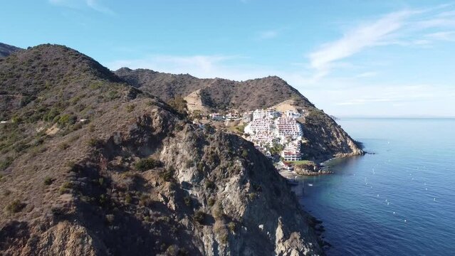 Hamilton Cove, Catalina Island. An exclusive villas located just north of Avalon harbor.  Tugged away in the hillside. Drone shot pulling away revealing rocky hillsides.