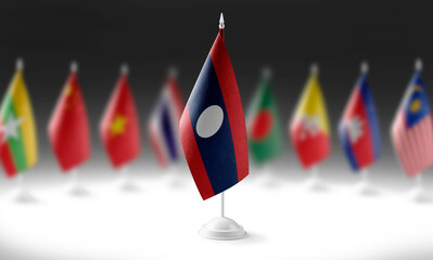 The national flag of the Laos on the background of flags of other countries