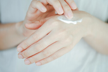 Woman applying moisturizing hand cream, Concept of health care of the hand.