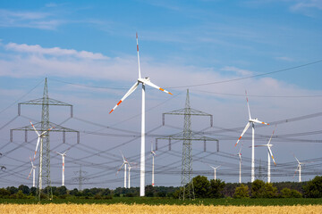 Various power lines and wind turbines seen in Germany