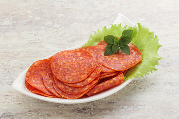 Sliced pepperoni sausage in the bowl