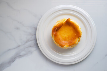 Homemade Basque Burnt Cheesecake. Dairy dessert. Top view on marble table.