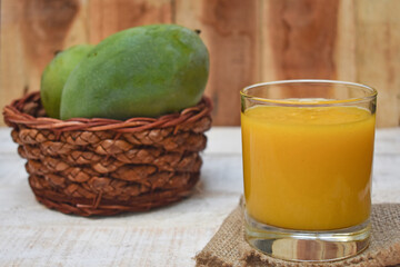 Fresh and sweet mango juice. Close up, served in a glass.
