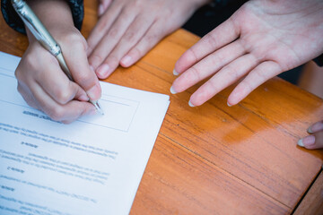 close up of businessman signing an agreement letter during meeting