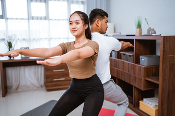 Fototapeta na wymiar portrait of beautiful young couple exercising together. healthy lifestyle at home