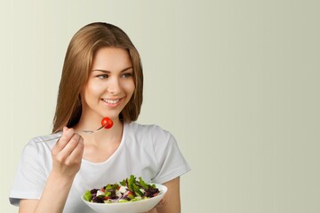 Sport, wellbeing and active lifestyle concept. Happy female athlete fitness girl holding salad