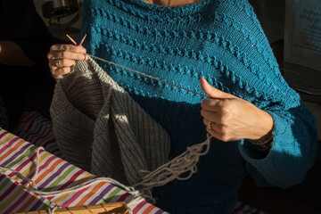 Zwei strickende Hände