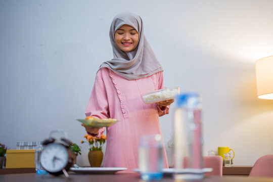 muslim woman wake up early to have a morning breakfast on fasting month. sahur concept in ramadan