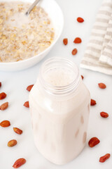 Fototapeta na wymiar Natural protein milkshake made of peanut. Fresh vegan nut milk or cream. Alternative dairy drink.