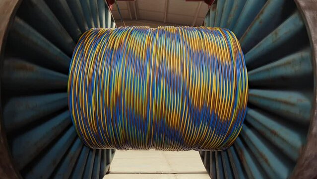Winding of the electrical cable to the bobbin in the production. Cable production. cable factory. 4K
