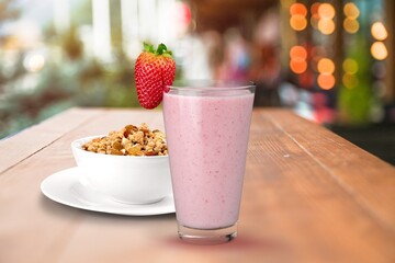 Glass of tasty berry smoothie with oatmeal on kitchen table