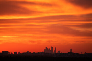 Fototapeta na wymiar Skyline of Moscow city at sunset, Russia. Orange sky with clouds 