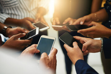 Business people hands typing on a phone, closeup texting on social media or reading emails or online news. Diverse group of colleagues social networking, looking at copyspace mobile screens.